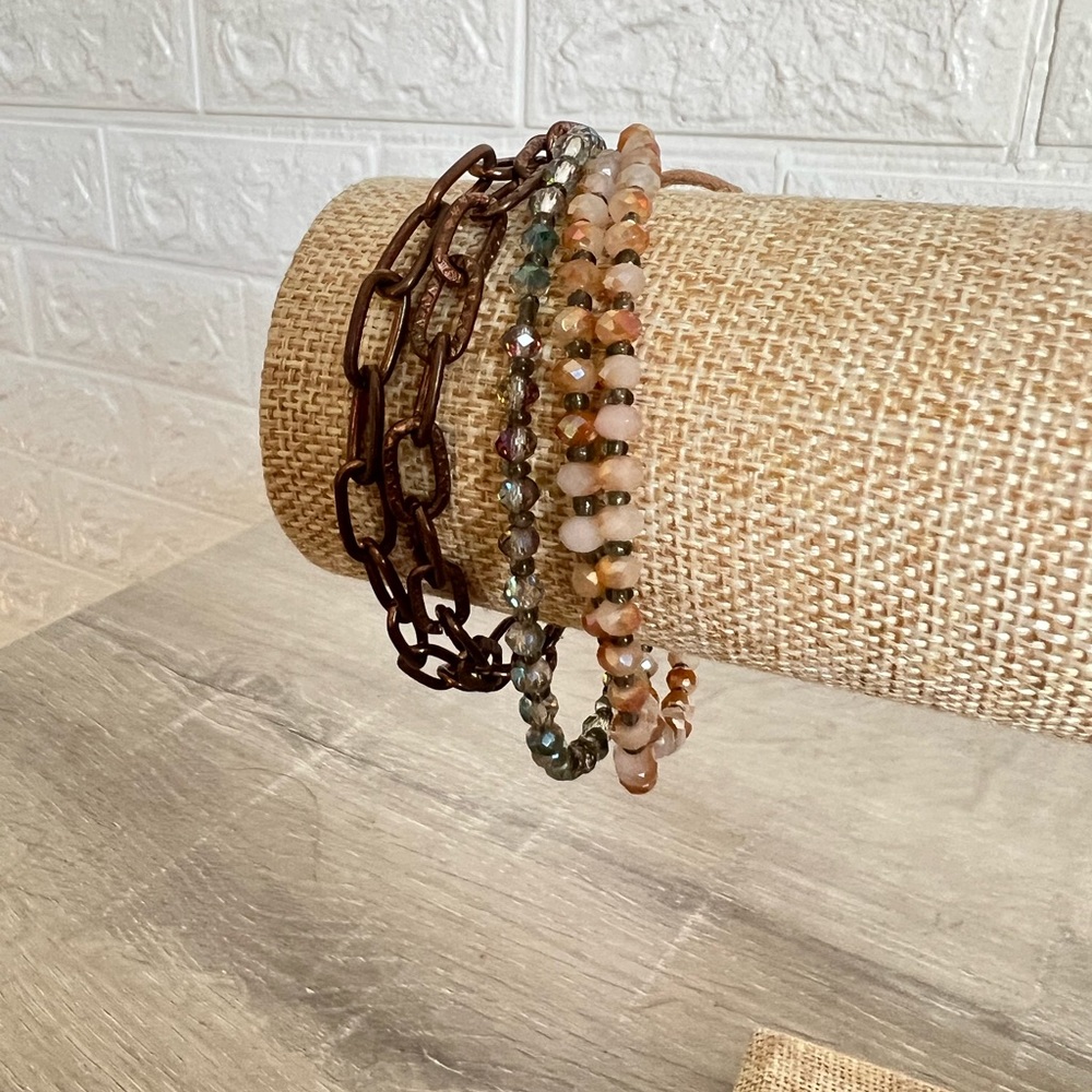 Multi textured bracelet with beads and chains.